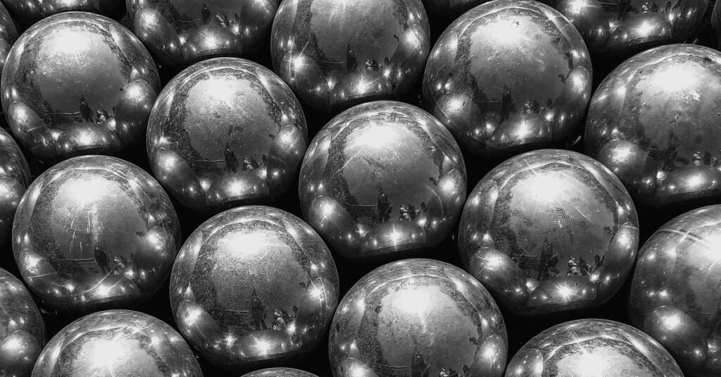 A detailed close-up of shiny silver balls creating an abstract pattern.